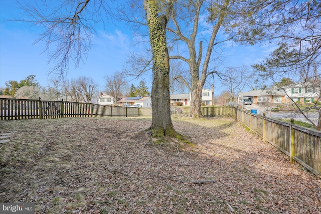 view of yard with a residential view and a fenced backyard