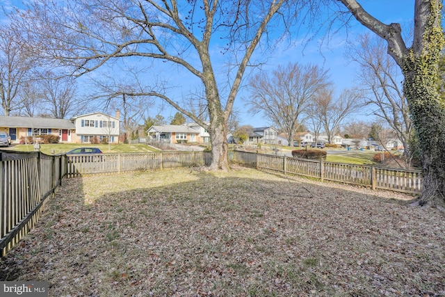 view of yard with a residential view and a fenced backyard