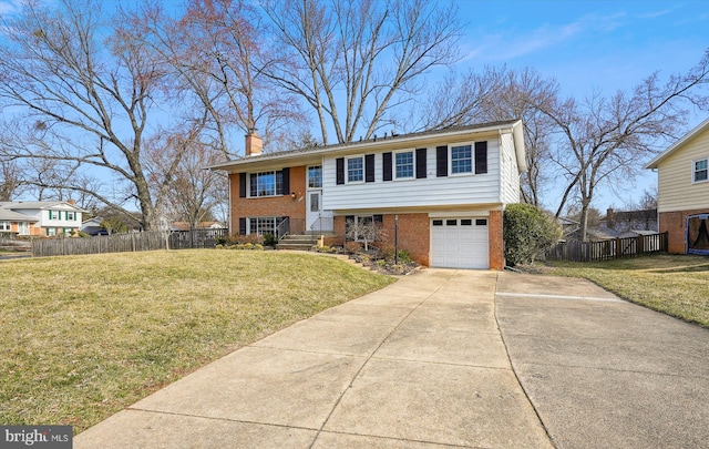 raised ranch with fence, driveway, a chimney, a front lawn, and brick siding