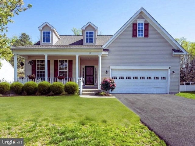 cape cod home featuring a porch, driveway, and a front yard