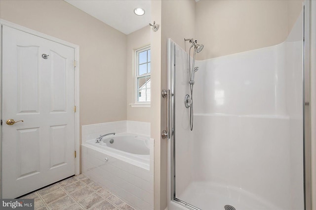 full bathroom featuring a shower stall and a garden tub