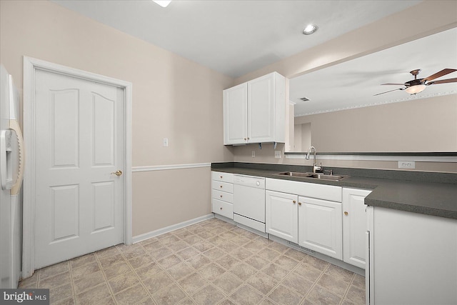 kitchen featuring white cabinets, dishwasher, a sink, dark countertops, and light floors