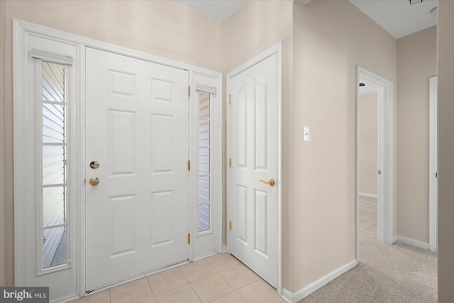 foyer with light tile patterned floors and baseboards