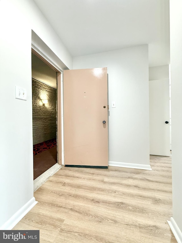 interior space featuring light wood finished floors and baseboards