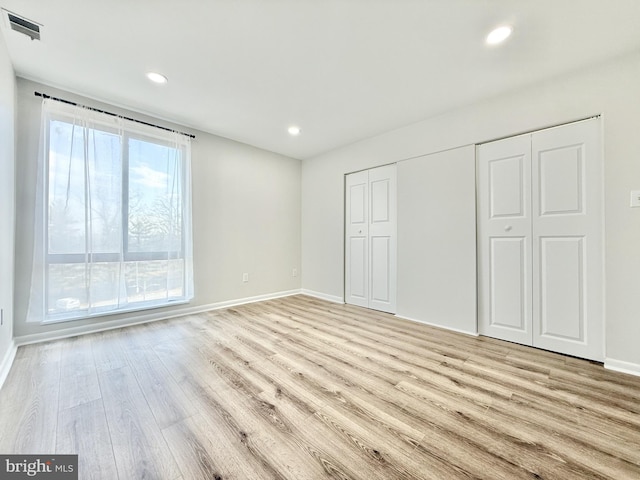 unfurnished bedroom featuring recessed lighting, baseboards, visible vents, and light wood finished floors