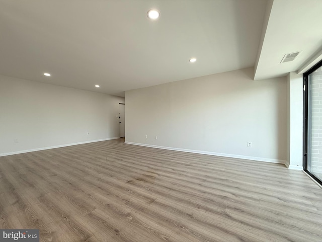 empty room with recessed lighting, baseboards, and light wood finished floors