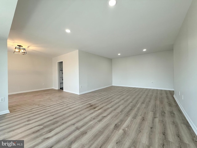 unfurnished room featuring recessed lighting, baseboards, and light wood finished floors