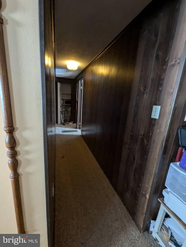 hallway with wood walls