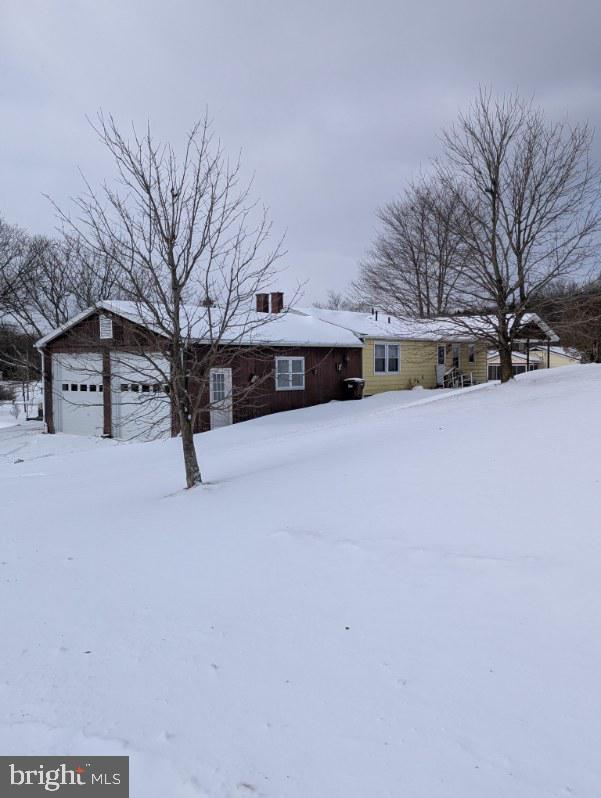 view of front of home with a detached garage