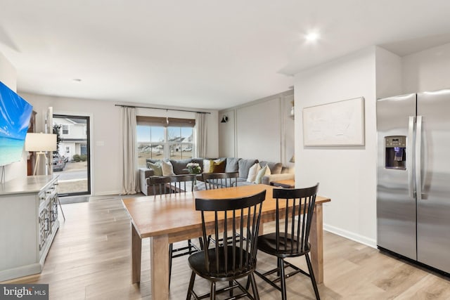 dining room with light wood-style floors and baseboards