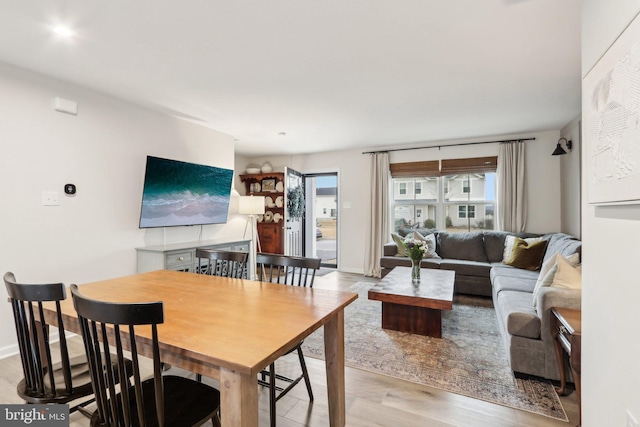 living room with light wood-style flooring and baseboards