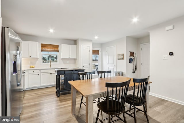 dining area with light wood finished floors, recessed lighting, and baseboards