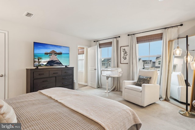 bedroom with visible vents and light colored carpet