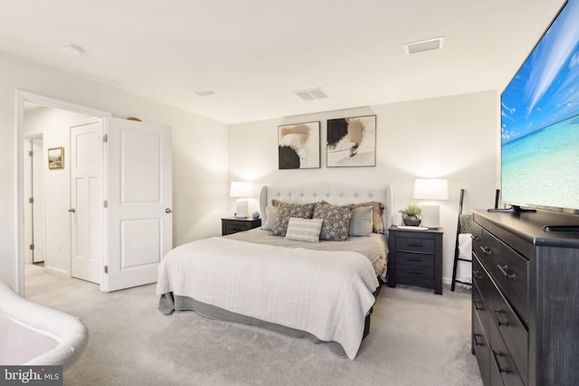 bedroom with light carpet and visible vents