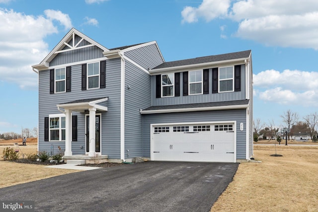 view of front of house with aphalt driveway, a garage, a shingled roof, board and batten siding, and a front yard