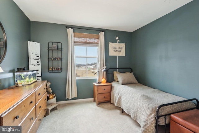 bedroom featuring baseboards and light colored carpet