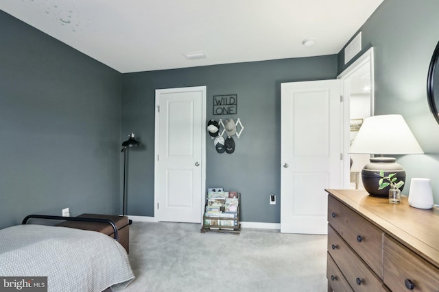 bedroom featuring light colored carpet and baseboards