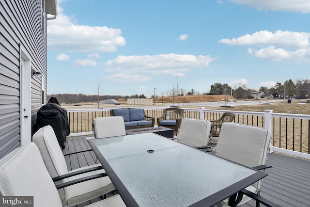 wooden terrace with outdoor dining space, grilling area, and an outdoor hangout area