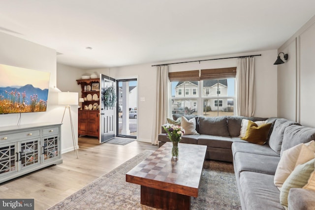 living area featuring baseboards and wood finished floors