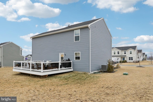 back of house with a deck, a yard, and cooling unit