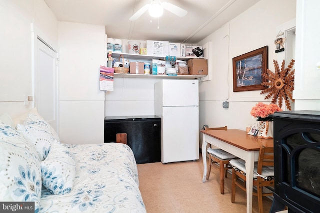 bedroom with light floors, refrigerator, and freestanding refrigerator