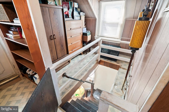 stairs with wooden walls and brick floor