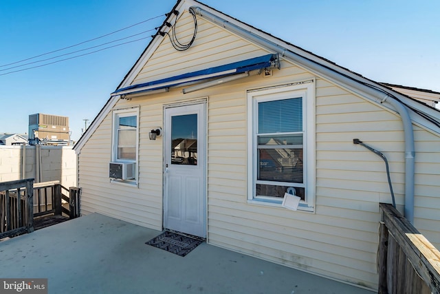 rear view of property with central AC unit, cooling unit, fence, and a patio