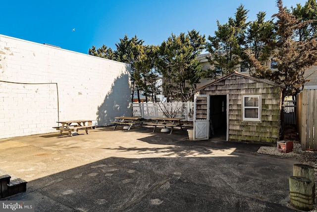 exterior space with a fenced backyard, a patio area, and an outdoor structure