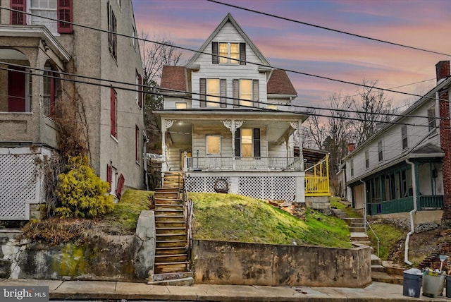 view of front facade featuring stairs and a porch