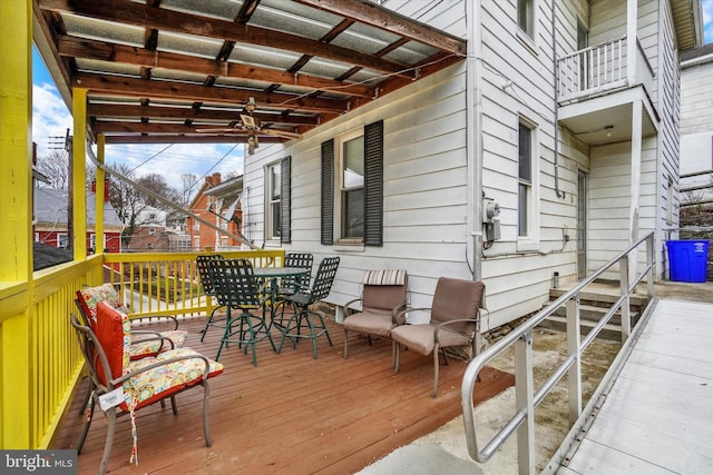 wooden terrace featuring outdoor dining area