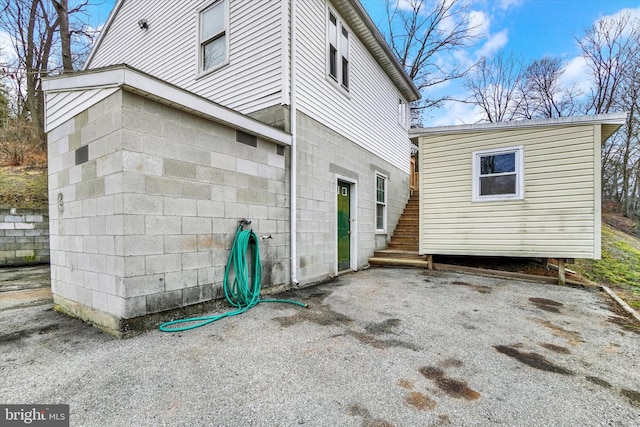 rear view of house featuring stairway