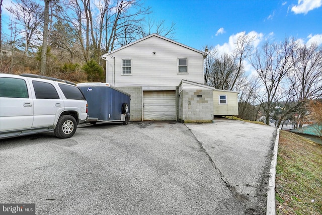 view of home's exterior with aphalt driveway