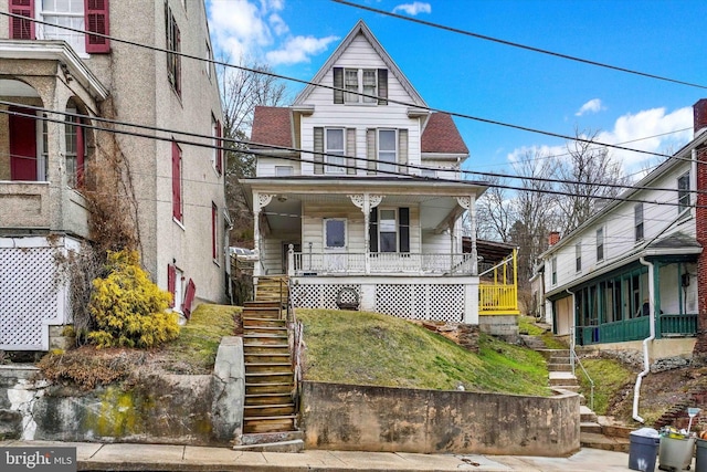 view of front of home with covered porch and stairs