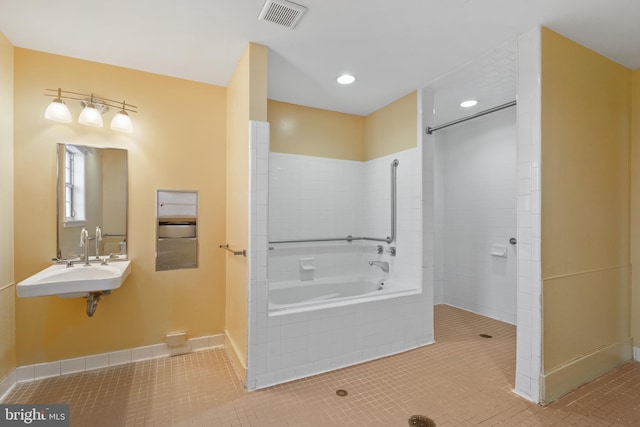 bathroom with visible vents, a bath, tile patterned floors, a tile shower, and a sink