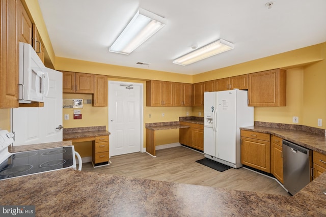 kitchen with white appliances, visible vents, light wood-type flooring, brown cabinets, and built in desk