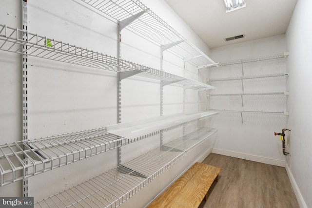 spacious closet with wood finished floors and visible vents