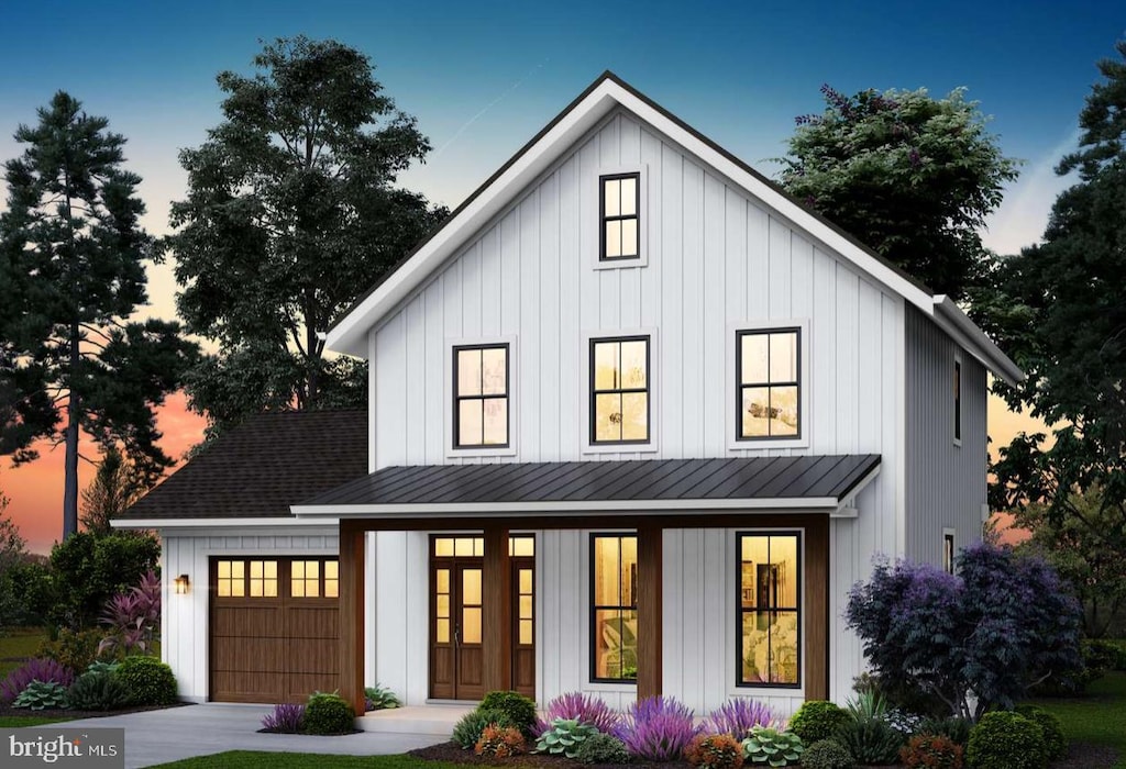 modern inspired farmhouse with board and batten siding, a standing seam roof, a garage, and concrete driveway