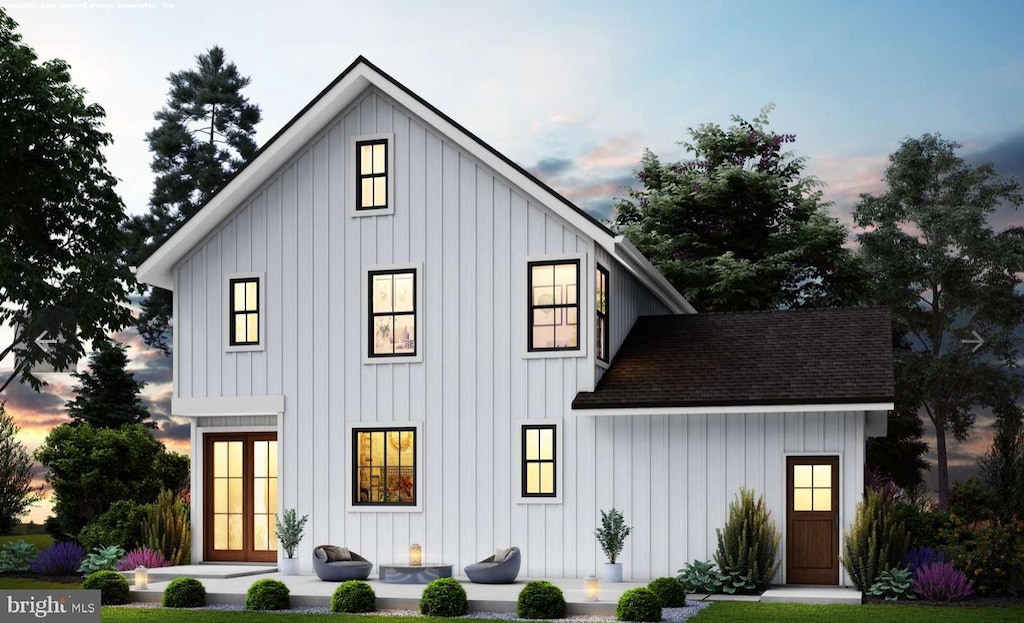 exterior space with a shingled roof and board and batten siding