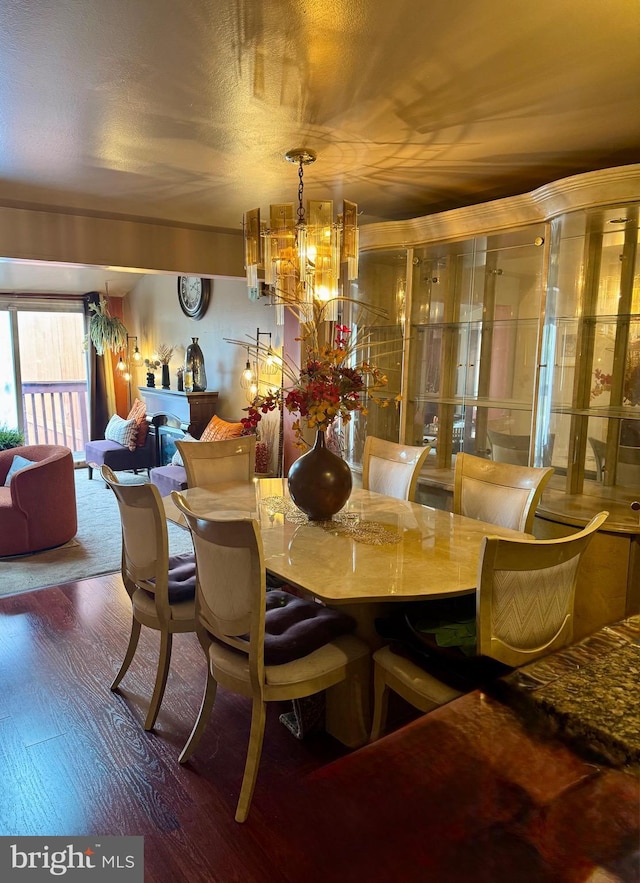 dining area featuring a notable chandelier and wood finished floors