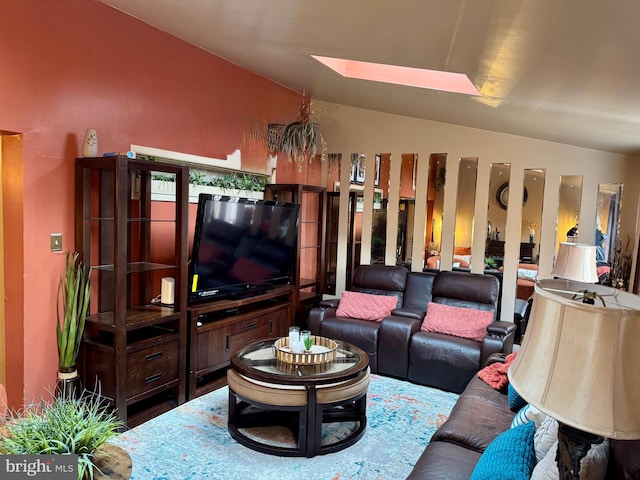 living area with lofted ceiling with skylight