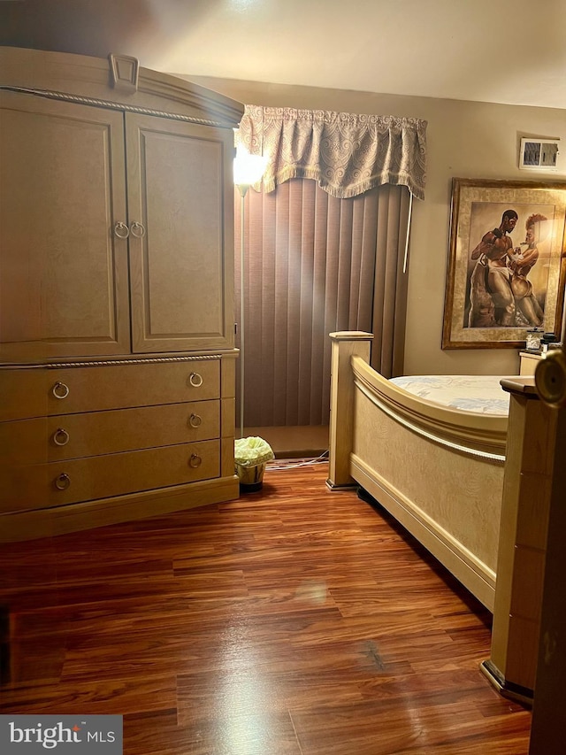 bedroom with wood finished floors and visible vents