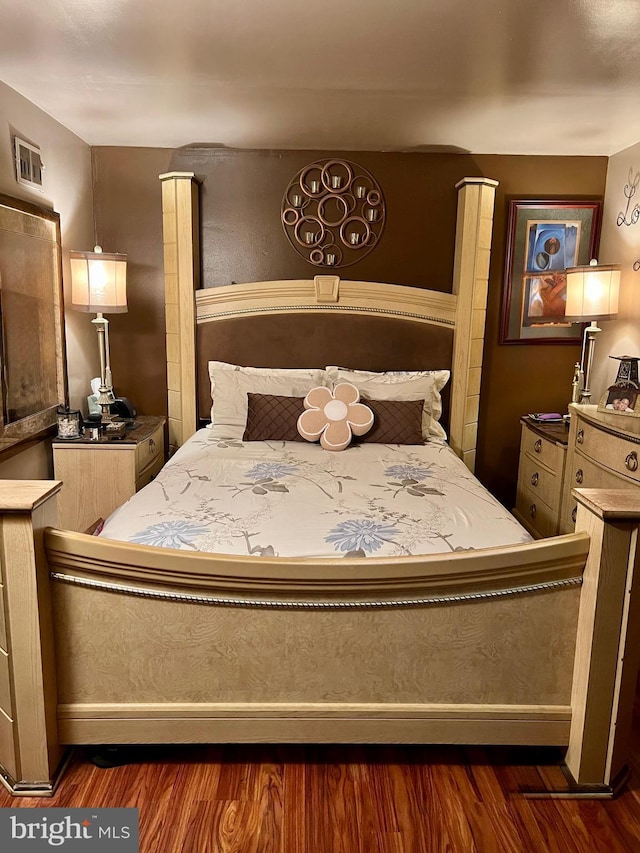 bedroom with dark wood finished floors