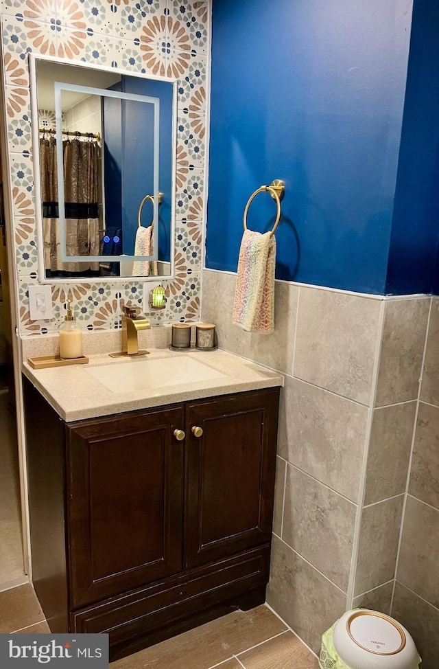 bathroom featuring tile walls and vanity