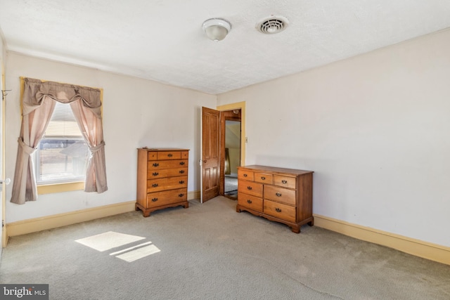 carpeted bedroom with visible vents and baseboards