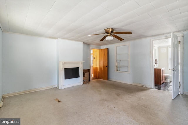 unfurnished living room featuring carpet, a fireplace, visible vents, and ceiling fan