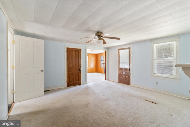 unfurnished bedroom with carpet floors, visible vents, ceiling fan, and baseboards