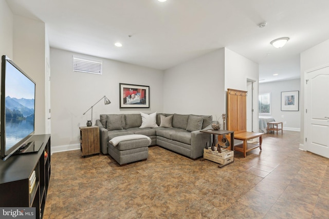 living area featuring recessed lighting and baseboards