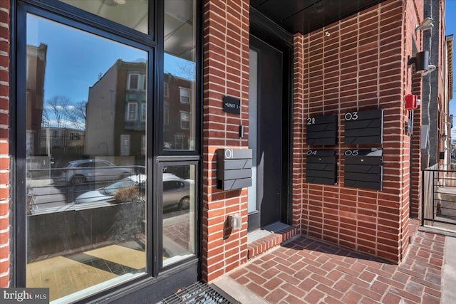 property entrance featuring brick siding