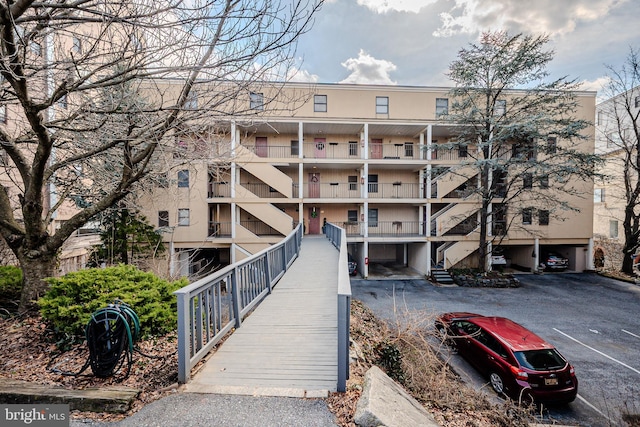 view of building exterior featuring uncovered parking