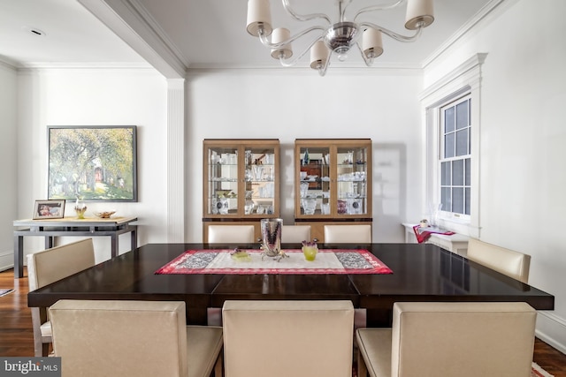 dining space with a notable chandelier, wood finished floors, baseboards, and ornamental molding